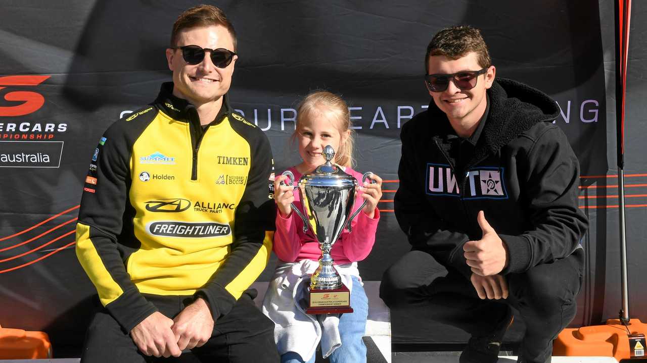 Hayley Bayada poses with drivers Tim Slade and Todd Hazelwood at the Supercars fan day at Orion on Saturday. Picture: Rob Williams