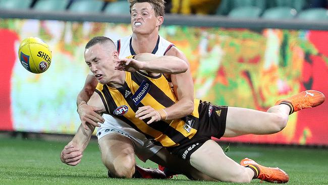 Tom Scully gets a handball away despite pressure from Adelaide’s Matt Crouch. Picture: Sarah Reed