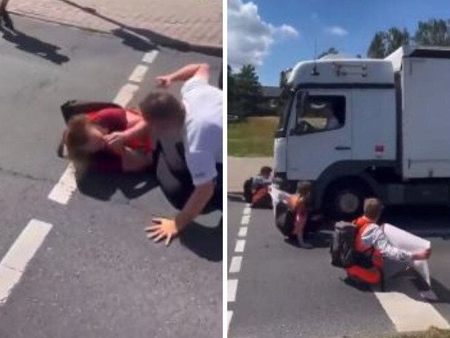 Dramatic footage has captured the moment a truckie dragged protesters off the road before almost running them over.