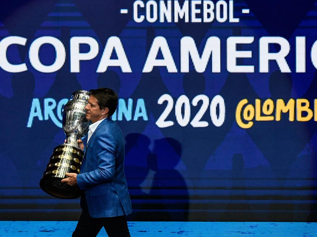 Brazilian former footballer Juninho Paulista presents the Copa America trophy on the stage during the draw of the Copa America 2020 football tournament. Picture: AFP