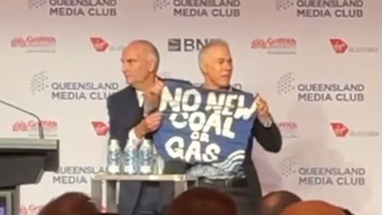 Protester Paul Gabbert is moved away from Treasurer Jim Chalmers after interrupting a pre-Budget speech at the Brisbane Media Club.