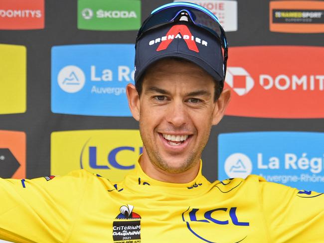 Team Ineos' Richie Porte of Australia celebrates his overall leader's yellow jersey on the podium at the end of the eighth stage, on the final day of the 73rd edition of the Criterium du Dauphine cycling race, a 147km between La Lechere-Les-Bains and Les Gets on June 6, 2021. (Photo by Alain JOCARD / AFP)