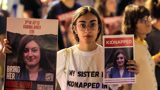 A woman holds placards identifying one of the Israeli hostages held by Palestinian militants since the October 7 attack. Picture: AFP