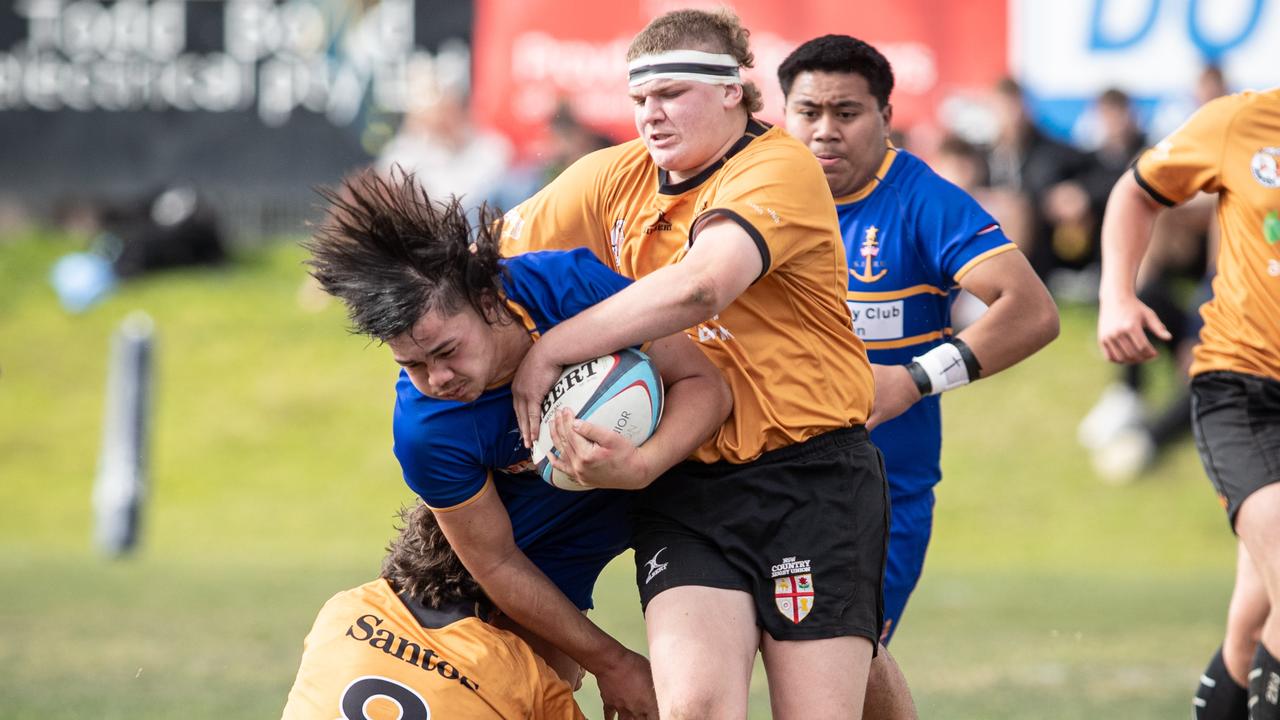 Sydney’s Tanner Mahon tackled by Darcy Emmett. s