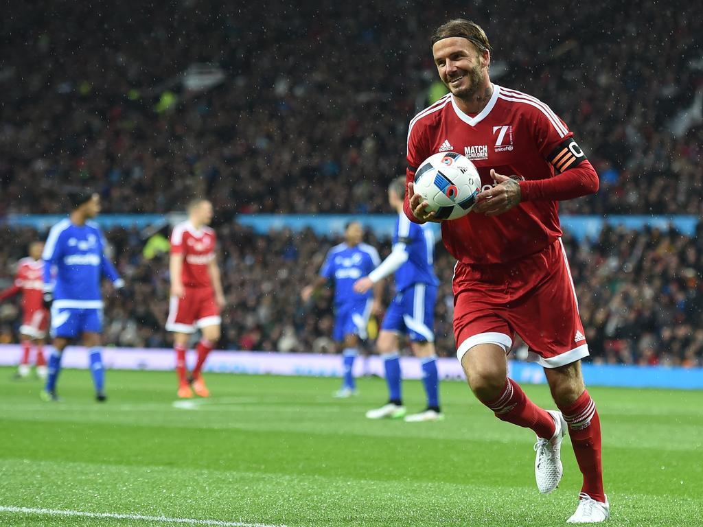 GB and Ireland’s English captain David Beckham runs to take a corner during a charity football match between a Great Britain and Ireland team and a Rest of the World team at Old Trafford in Manchester, on November 14, 2015 in aid of UNICEF. Picture: AFP