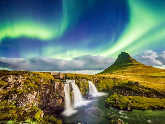 Scenic view of aurora over Kirkjufell and waterfall. Idyllic view of Northern Lights in Iceland. Beautiful view of nature at night.