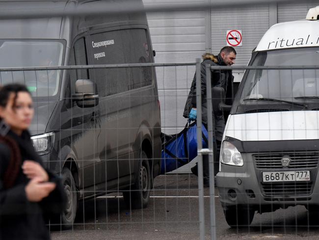 A police officer carries out the body of a victim of the Crocus City Hall terror attack. Picture: AFP