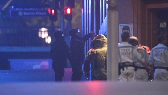 Heavily armed police, including the Bomb Squad surround the Lindt Cafe. Picture: Bill Hearne