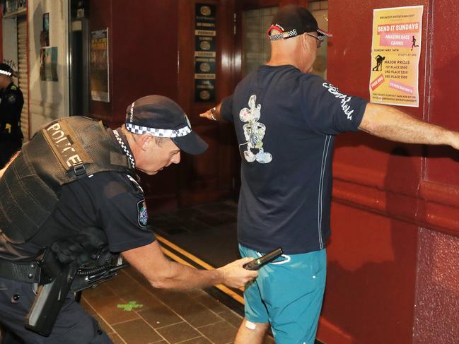 Queensland Police officers conduct a wanding operation, searching for concealed knives and weapons on patrons in the Cairns Safe Night Precinct using newly commissioned metal detector wands. Picture: Andrew McKenna