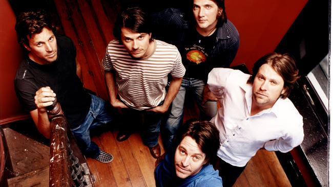 Powderfinger are back … for one night only. Clockwise from left: Jon Coghill, Darren Middleton, Ian Haug, John Collins, Bernard Fanning (foreground). Picture: Ian Jennings, 2004.