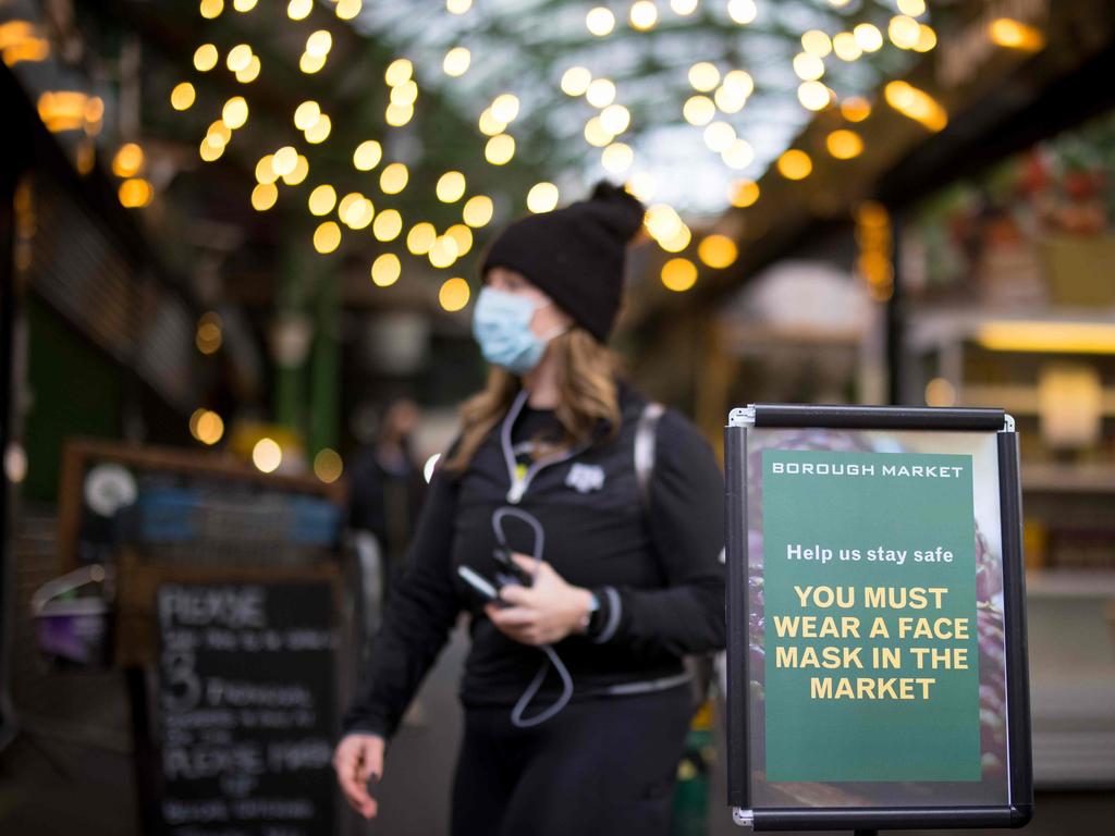 A sign informs people that it is mandatory to wear face masks at popular Borough Market in London on January 12. Picture: Tolga Akmen / AFP)