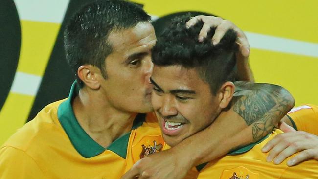 Massimo Luongo gets a peck from Tim Cahill.