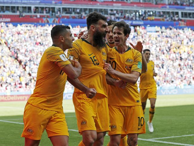 Mile Jedinak celebrates scoring a goal with teammates Andrew Nabbout and Robbie Kruse. Picture: Toby Zerna