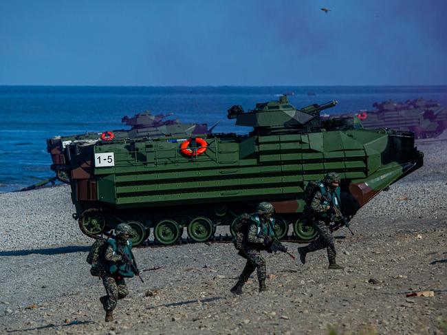 PINGTUNG, TAIWAN - JULY 28: Soldiers disembark from AAV7 amphibious assault vehicles during the Han Kuang military exercise, which simulates China's People's Liberation Army (PLA) invading the island, on July 28, 2022 in Pingtung, Taiwan. Taiwan military launches five days of live fire drills involving all forces of the military to repel simulated attacks from China. (Photo by Annabelle Chih/Getty Images)