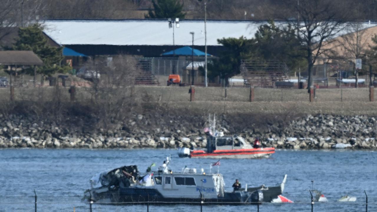 A police boat gathers wreckage along the Potomac River after American Airlines flight 5342. (Photo by PEDRO UGARTE / AFP)