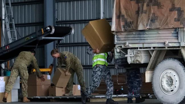 Diagnostic components for the coronavirus testing machine arrive via the RAAF at Christmas Island airport. Picture: Colin Murty