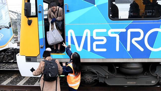 Passengers forced to leave the stricken train.(AAP Image/Joe Castro)