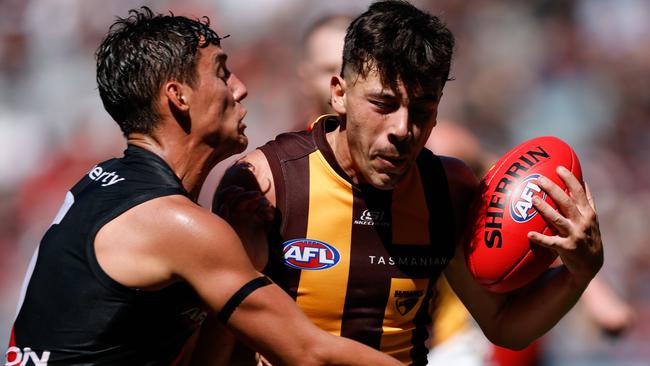 MELBOURNE, AUSTRALIA - MARCH 16: Massimo D'Ambrosio of the Hawks is tackled by Jye Caldwell of the Bombers during the 2024 AFL Round 01 match between the Essendon Bombers and the Hawthorn Hawks at the Melbourne Cricket Ground on March 16, 2024 in Melbourne, Australia. (Photo by Dylan Burns/AFL Photos via Getty Images)