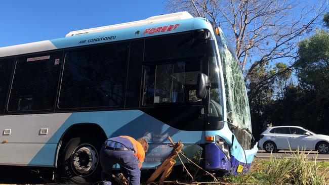 Authorities work to remove a Forest Coach Lines bus that was badly damaged when it left Forest Way at Belrose. Picture: Abby O’Rourke