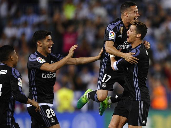 Real Madrid's Cristiano Ronaldo celebrates with teammates.
