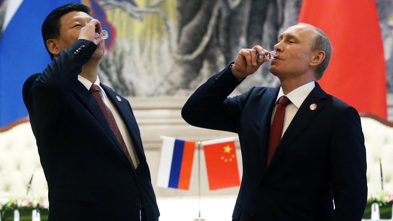 President of Russia Vladimir Putin and Chinese President Xi Jinping toast with vodka during a signing ceremony on May 21, 2014 in Shanghai, China. Russia and China signed a thirty-year contract for supply of gas. Picture: Sasha Mordovets/Getty Images.