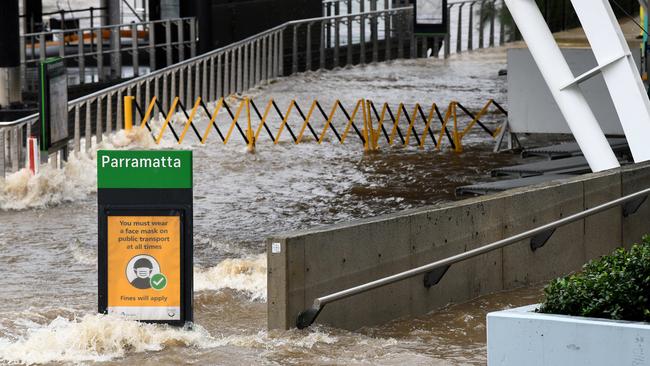 The footpath is submerged by floodwater as the Parramatta River overflows at the Charles Street weir and ferry wharf at Parramatta in Sydney. Picture: NCA NewsWire/Bianca De Marchi