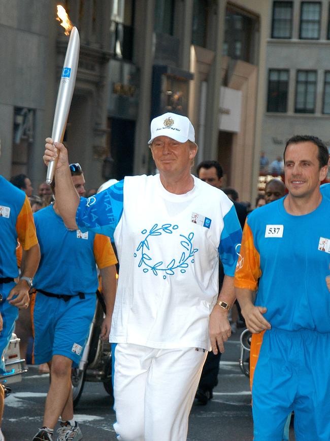 Donald Trump carries the Olympic flame during Day 15 of the Athens 2004 Olympic Torch Relay in New York on June 19, 2004. Picture: Getty