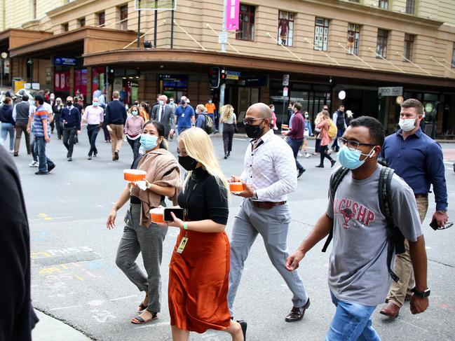 Masked pedestrians in the Brisbane CBD yesterday. Picture: David Clark