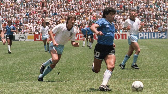 Diego Maradona runs past defenders Terry Butcher, left, and Terry Fenwickon his way to scoring his second goal during the 1986 World Cup quarterfinal soccer match between Argentina and England. Picture: AFP