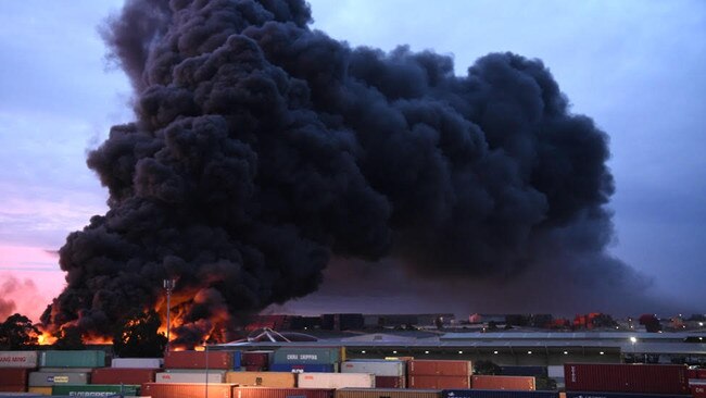 Thick black smoke spews over the city’s west. Picture: Nicole Garmston