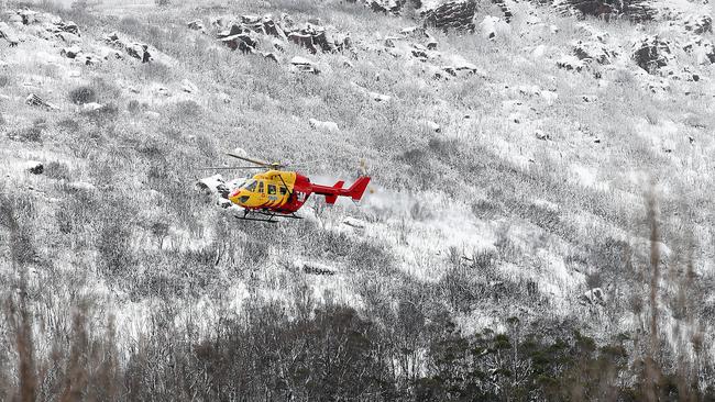 The Westpac rescue helicopter rescues an injured snowboarder at the top of The Needles West of Maydena. Picture: ZAK SIMMONDS