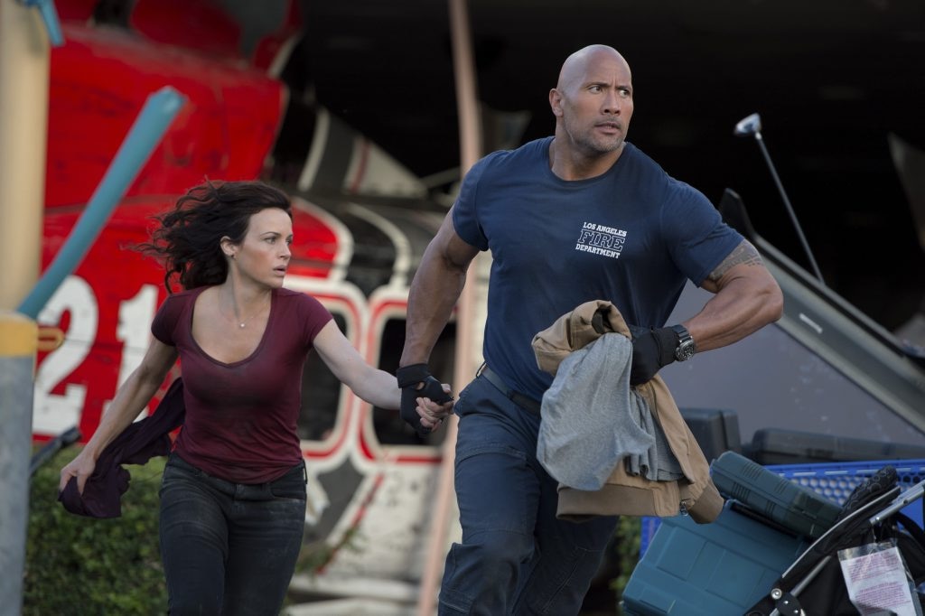 ON THE MOVE: Carla Gugino and Dwayne 'The Rock' Johnson in a scene from the movie San Andreas. Jasin Boland. Picture: Jasin Boland