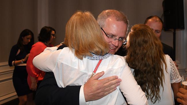 Australian Prime Minister Scott Morrison hugs party faithful as he arrives at the Liberal Party Wentworth by-election function. Picture: AAP