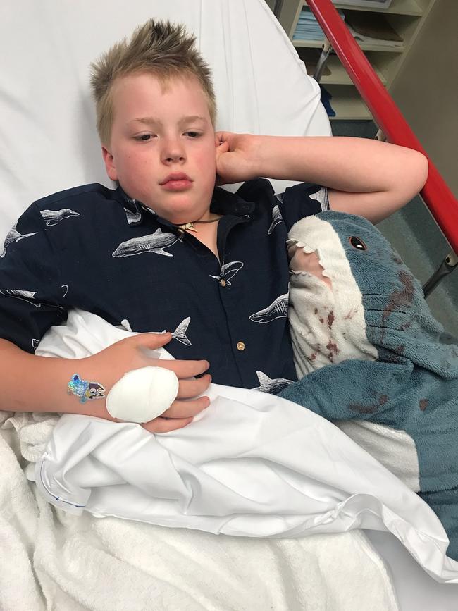 Huck Myers, 9, with his pet toy “Sharky” recovers in the Women's and Children's Hospital after he was stabbed during a violent car robbery outside his family's Unley home. Picture supplied by family