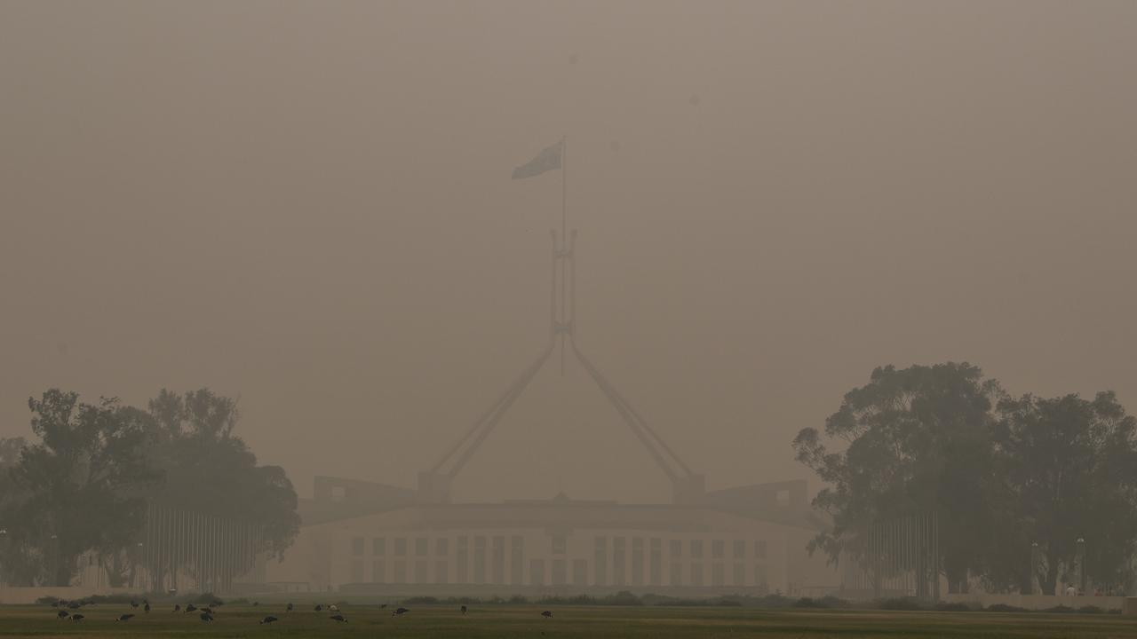 Parliament House was barely visible on New Year’s Day. Picture: AAP Image/Lukas Coch