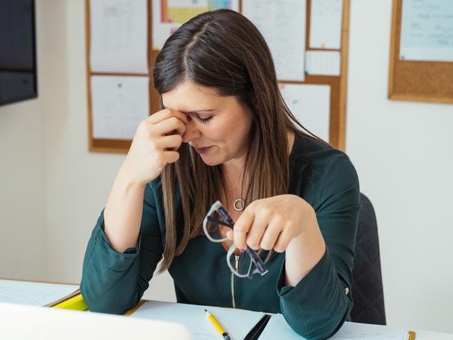 Teacher holding online class for e-learning students during covid-19 pandemic period. Stressed woman sitting in her home office during class break, take off glasses feel pain rub closed eyes tired of computer screen.