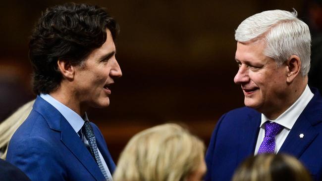 Former Canadian Prime Minister Justin Trudeau (L) and former political foe Stephen Harper were seated together in a show of national unity. Picture: AFP