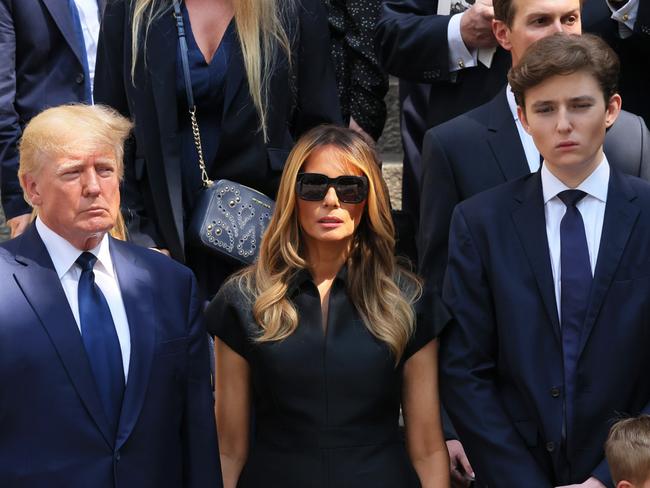 NEW YORK, NEW YORK - JULY 20: former U.S. President Donald Trump and his wife Melania Trump along with their son Barron Trump and Ivanka Trump, Eric Trump and Donald Trump Jr. and their children watch as the casket of Ivana Trump is put in a hearse outside of St. Vincent Ferrer Roman Catholic Church during her funeral on July 20, 2022 in New York City. Trump, the first wife of former U.S. President Donald Trump,  died at the age of 73 after a fall down the stairs of her Manhattan home. (Photo by Michael M. Santiago/Getty Images)