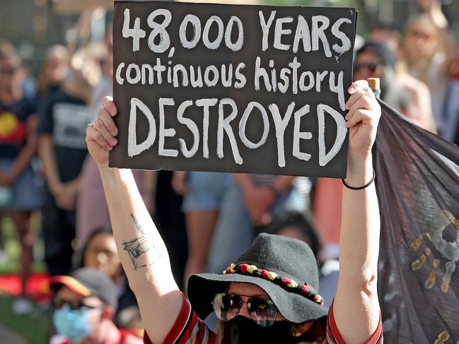 Protesters are seen during a rally outside the Rio Tinto office in Perth, Tuesday, June 9, 2020.. Rio Tinto recently detonated explosives in an area of the Juukan Gorge in the Pilbara, destroying two ancient deep-time rock shelters, much to the distress of the Puutu Kunti Kurrama and Pinikura people. (AAP Image/Richard Wainwright) NO ARCHIVING