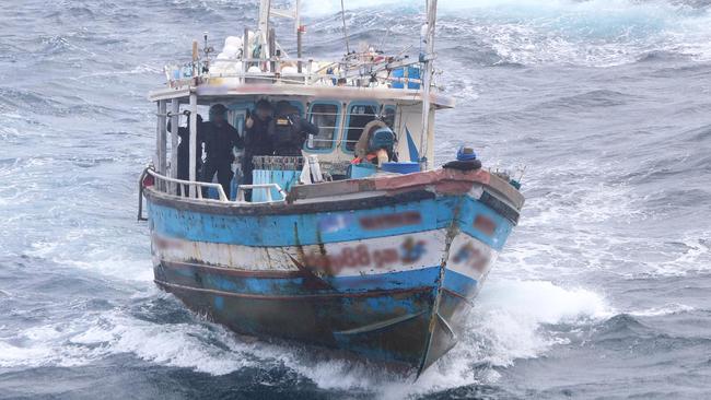 Australian Border Force agents take control of a boat intercepted west of Christmas Island.