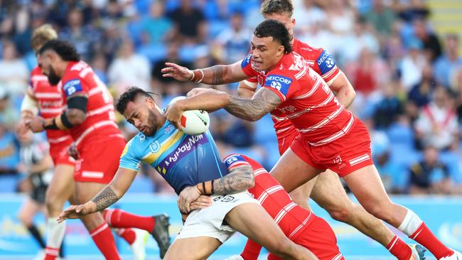 Phillip Sami of the Titans is tackled during the round six NRL match between Gold Coast Titans and St George Illawarra Dragons at Cbus Super Stadium. (Photo by Chris Hyde/Getty Images)