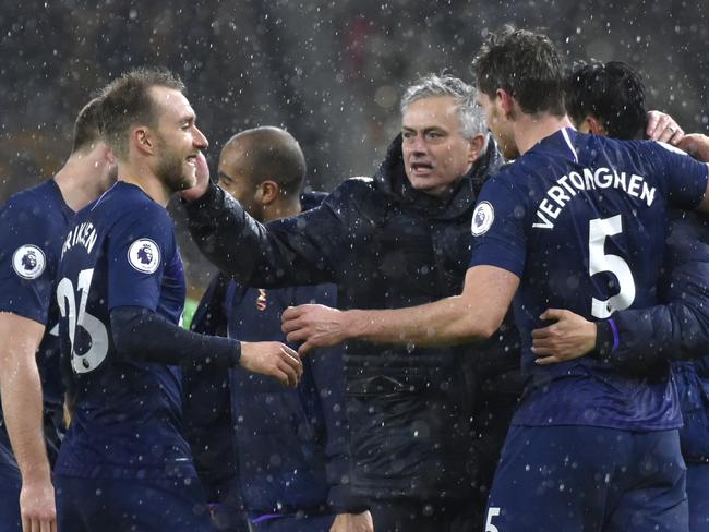 Tottenham's manager Jose Mourinho, centre, celebrates with his players at the end of the the English Premier League soccer match between Wolverhampton Wanderers and Tottenham Hotspur at the Molineux Stadium in Wolverhampton, England, Sunday, Dec. 15, 2019. (AP Photo/Rui Vieira)