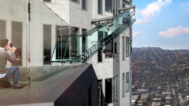 This undated artist's rendering provided by Overseas Union Enterprise Limited shows a glass slide 1,000 feet above the ground off the side of the U.S. Bank Tower in downtown Los Angeles. The 45-foot-long attraction is part of a $50 million renovation that will also put a bar and open-air observation deck on the top floors of the 72-story building. (Michael Ludvik/ OUE Ltd. via AP)