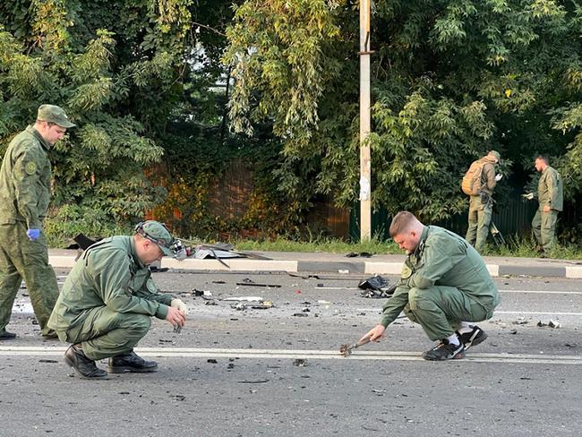 Investigators work on the explosion site of a car driven by Daria Dugina. Picture: Investigative Committee of Russia / AFP