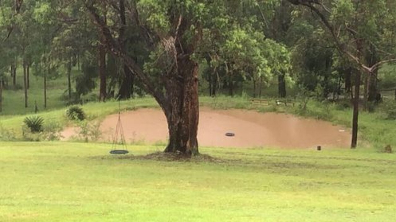 Ms Miles' dam in her backyard has overflown.