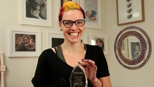 Award-winning newborn baby photographer Tiffany Selzer with her trophy. Picture: Hamish Blair
