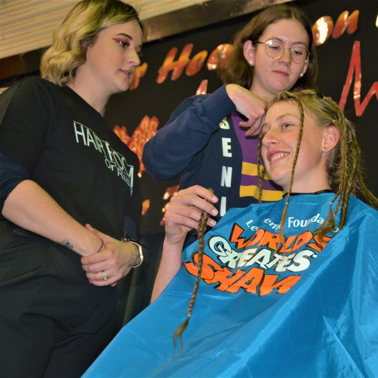 At the St Joseph's College 2023 World's Greatest Shave event is student Emily Chandler getting her hair cut by her support crew and hairdresser Natalie Schmidt from the Hair Room on Russell. Picture: Rhylea Millar