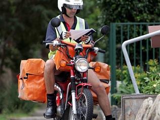  Generic pic of an Australia Post worker (postman) on his motorbike (motorcycle) in Sydney. New regulations have raised the m...