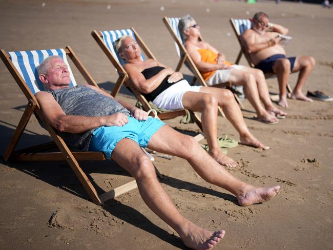 High vaccination rates have allowed many Brits some semblance of a return to normality. Here people enjoy the sunshine and high temperatures on Whitby beach. Picture: Christopher Furlong/Getty Images