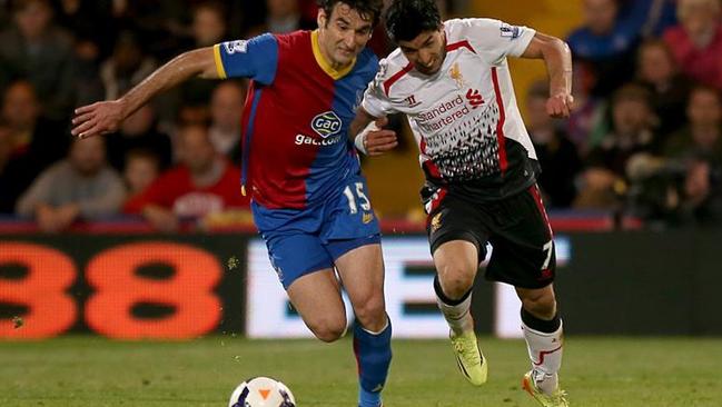 Liverpool's Luis Suarez (right) and Mile Jedinak (left) battle for the ball.